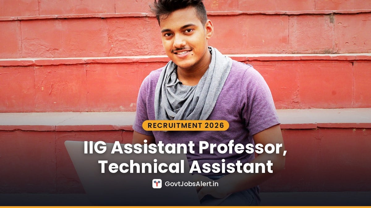 A young Indian candidate with a laptop sitting on red steps - IIG Recruitment 2026 Assistant Professor, Technical Assistant & Other Posts