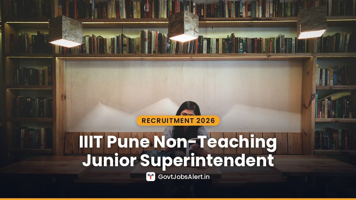 A student reading at a wooden desk in a library — IIIT Pune Non-Teaching Recruitment 2026 for Junior Superintendent and Junior Engineer posts