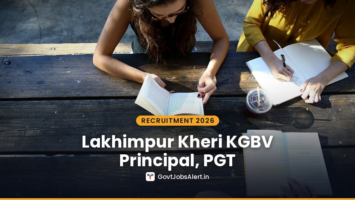 Students reading and writing notes at a wooden table - Lakhimpur Kheri KGBV Recruitment 2026 for women