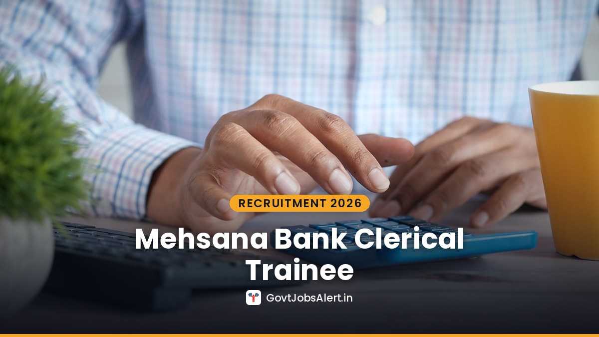 Hands typing figures on a calculator at a bank desk for MUCB Clerical Trainee Recruitment 2026 in Gujarat