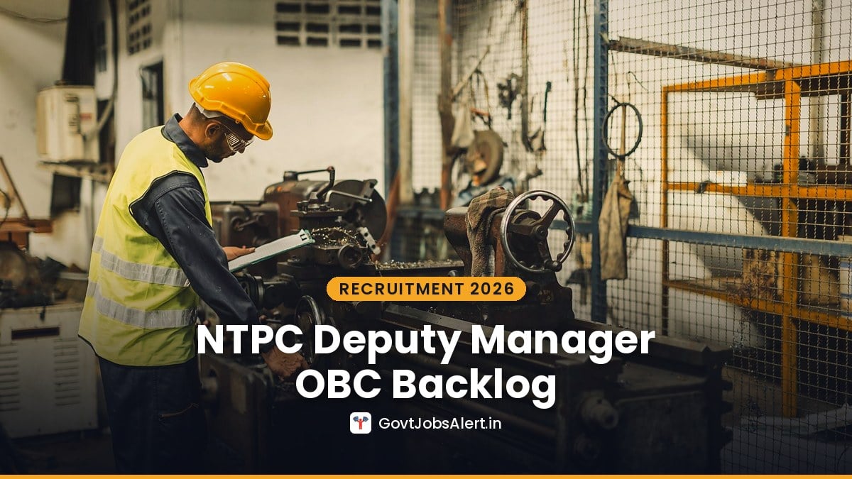 An engineer in a hard hat and safety vest checking a machine at an industrial workshop — NTPC Deputy Manager Recruitment 2026 for Mechanical, C&I and Civil posts