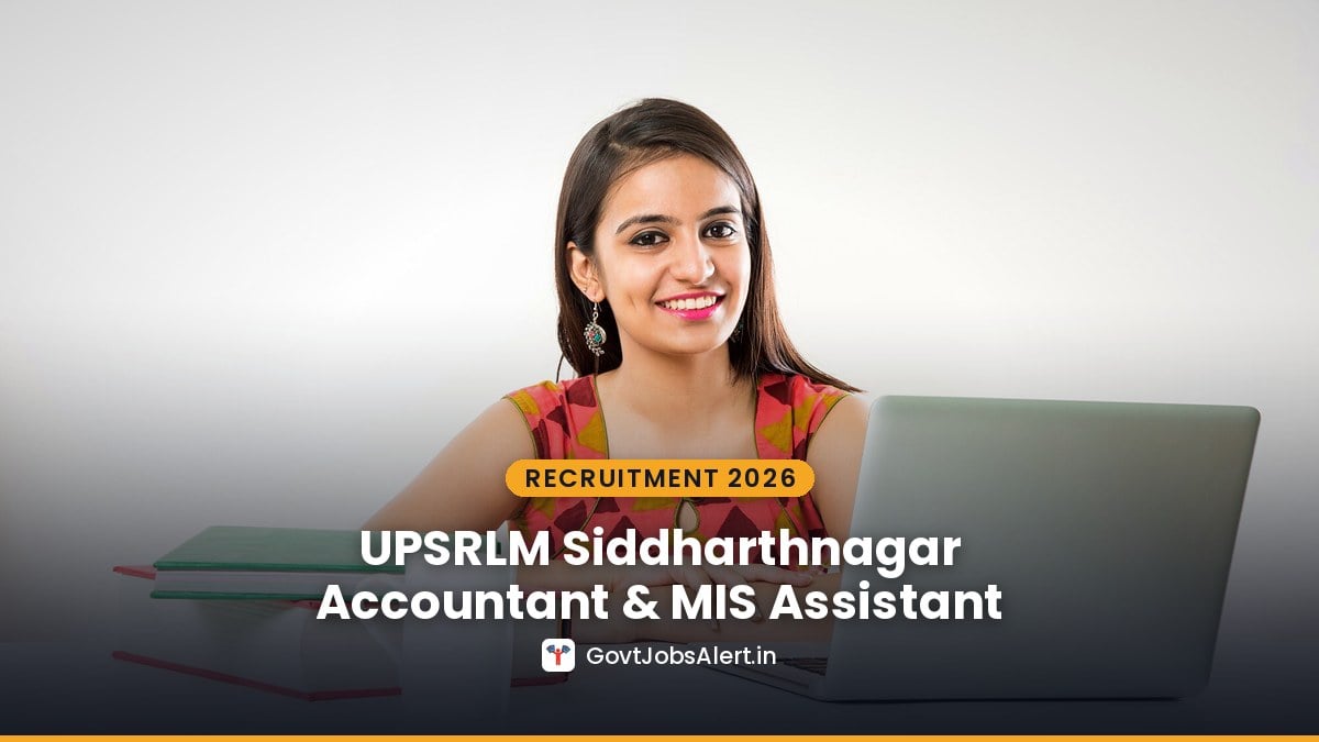 Young Indian woman working at a laptop with books on her desk — UPSRLM Siddharthnagar Accountant & MIS Assistant Recruitment 2026