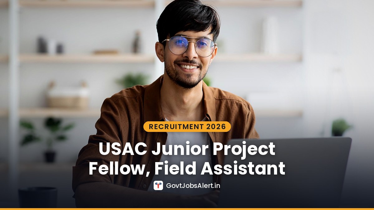 A smiling young man working on a laptop at a desk - USAC Dehradun Junior Project Fellow and Field Assistant Recruitment 2026